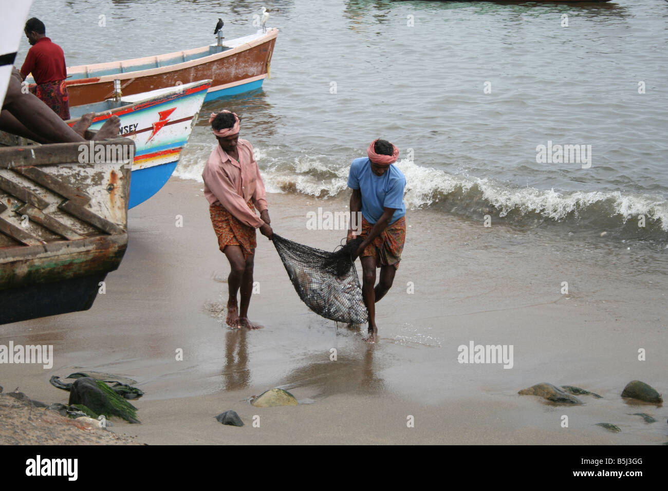 Indian Fishermen Carrying Huge Net Full Of Big Fishes They