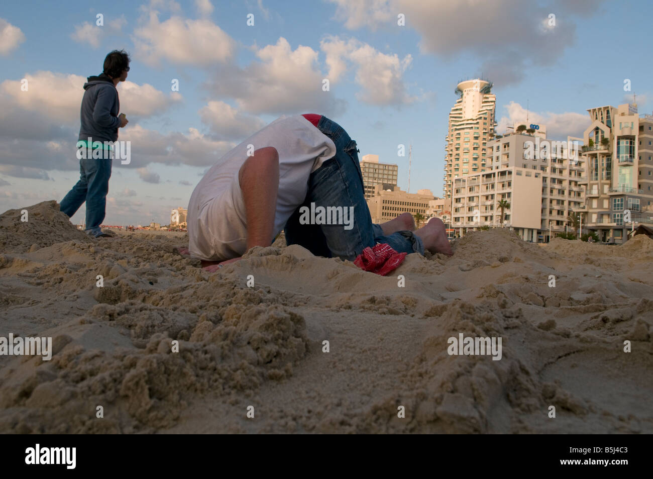 Person burying head in the sand hires stock photography and images Alamy