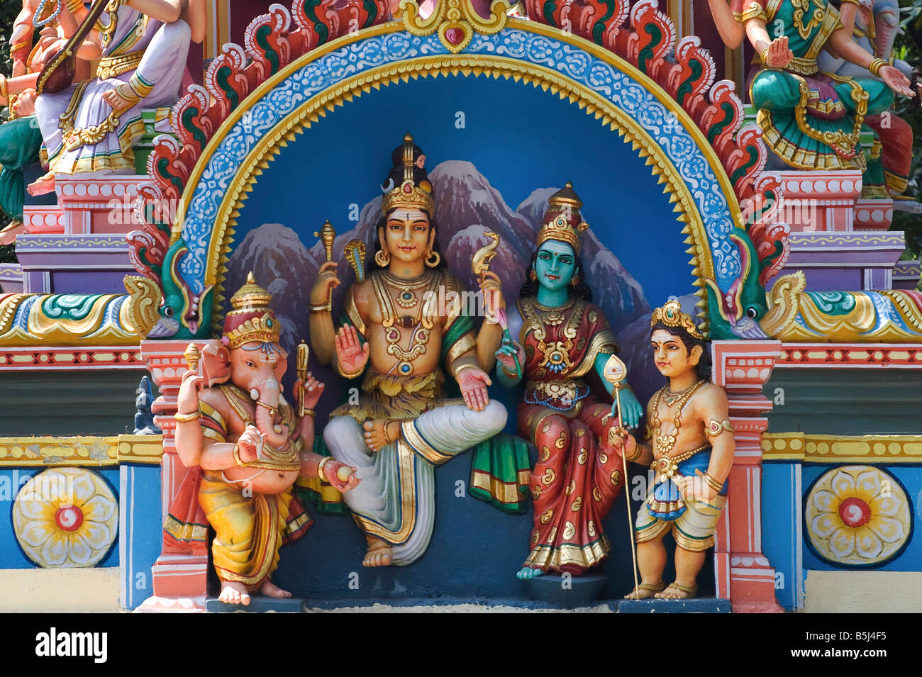 Hindu deities, sculpted painted statues, on a hindu temple in Stock