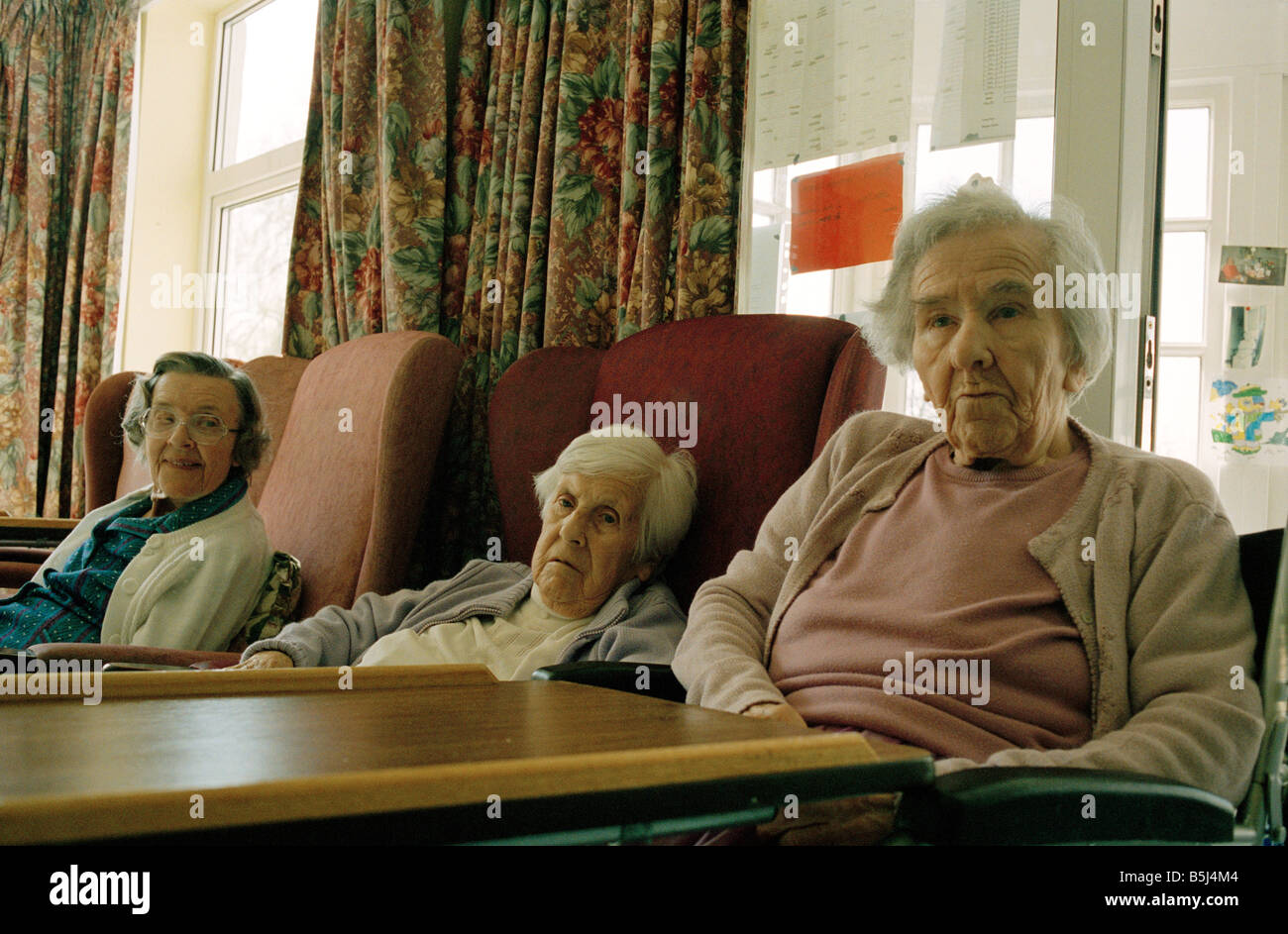 Three elderly residents at an old peoples home in England Stock Photo