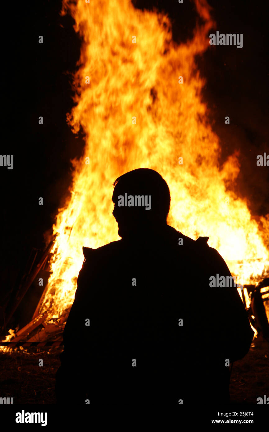 Man Silhouetted Against Bonfire Flames Stock Photo Alamy
