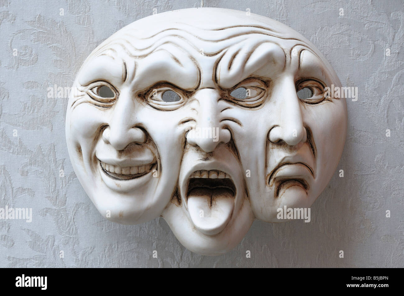 Trifaccia. Three faces mask, showing comedy, tragedy and rage, traditional carnival mask of Venice. Stock Photo