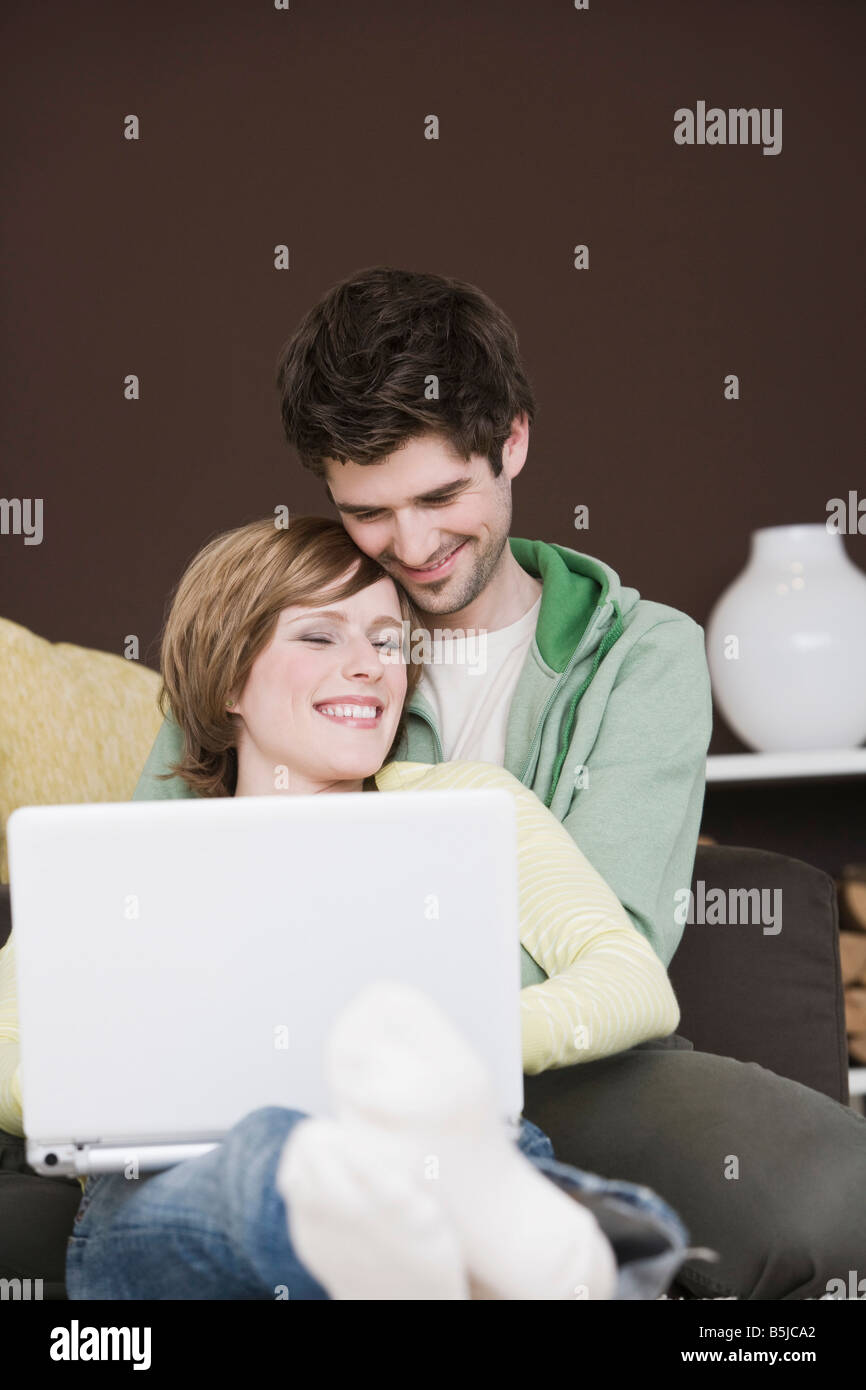 young couple at home working with laptop computer together Stock Photo ...