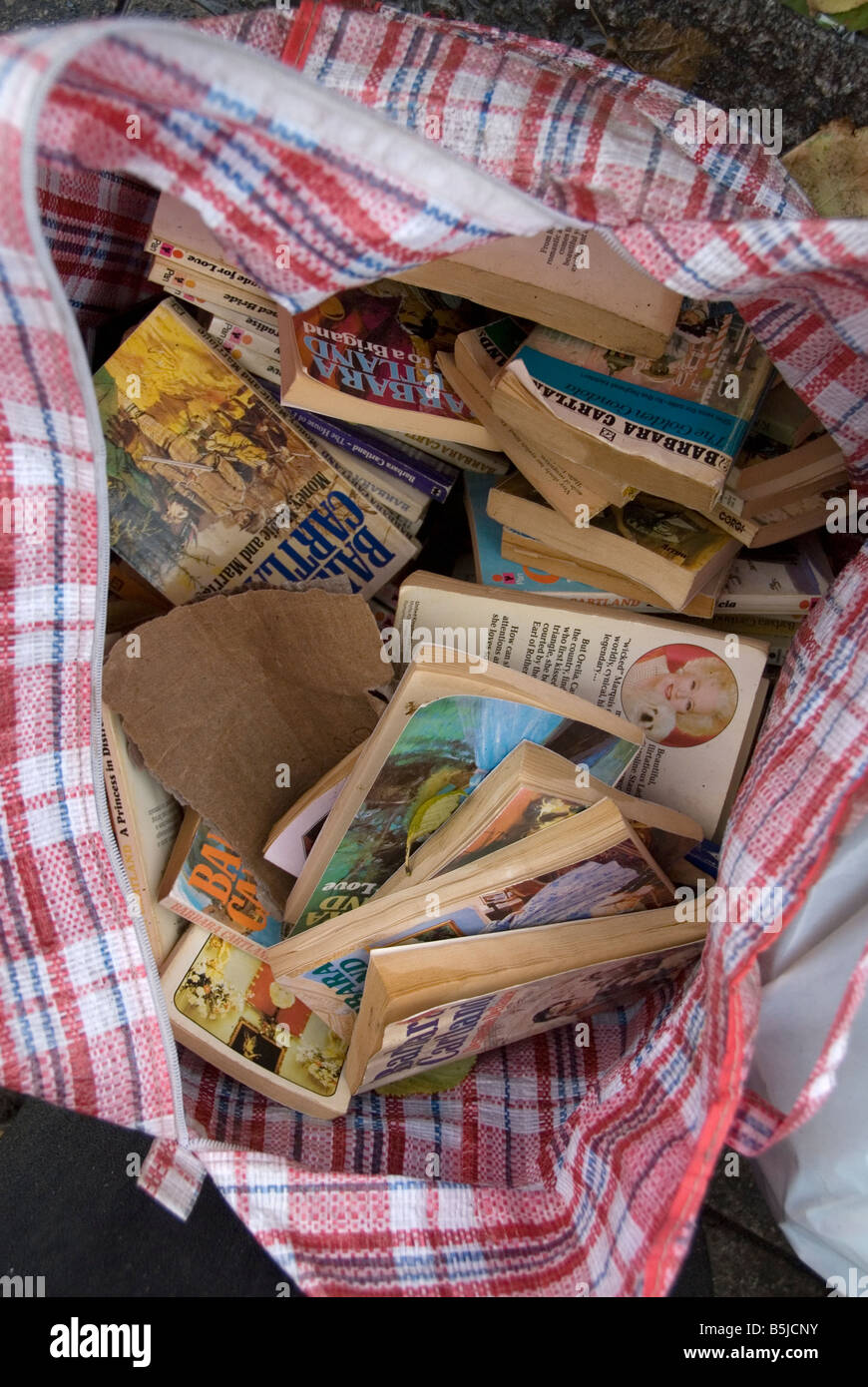 Broadway market. Bag full of Barbara Cartland novels thrown away as rubbish. Stock Photo