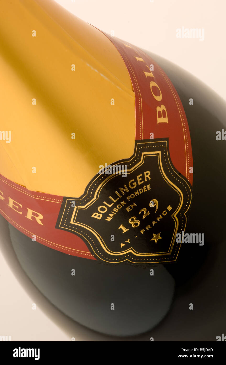 Closeup of gold foil and branding on the neck of a bottle of Bollinger Champagne, seen against a white background Stock Photo