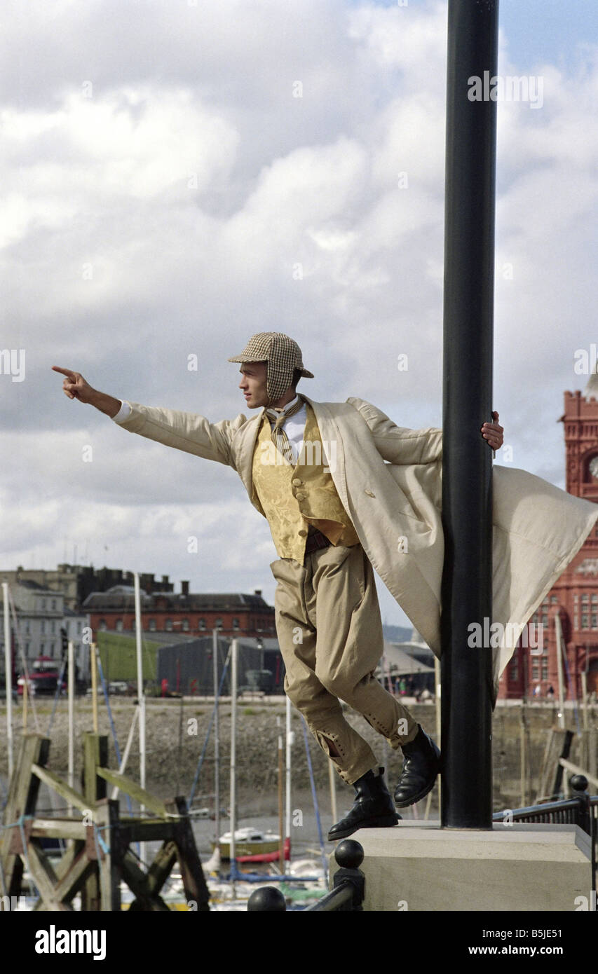 Man in Victorian Dress points across Harbour Stock Photo