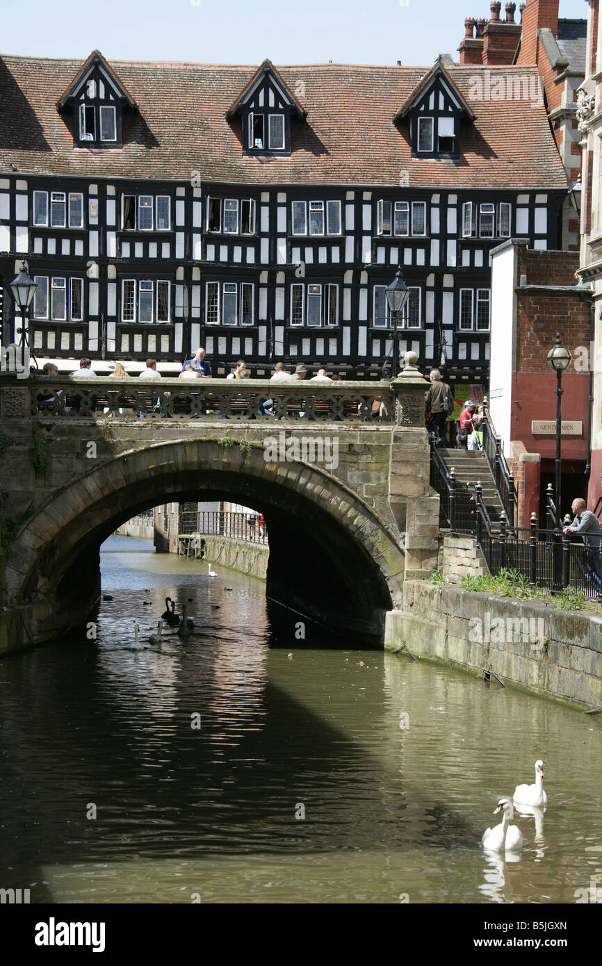 City of Lincoln, England. View of Lincoln’s medieval High Bridge over the River Witham with High Street shops on the bridge. Stock Photo