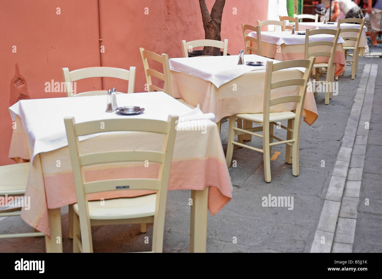 Tables and chairs in outdoor restaurant Greece Crete Rethymno September