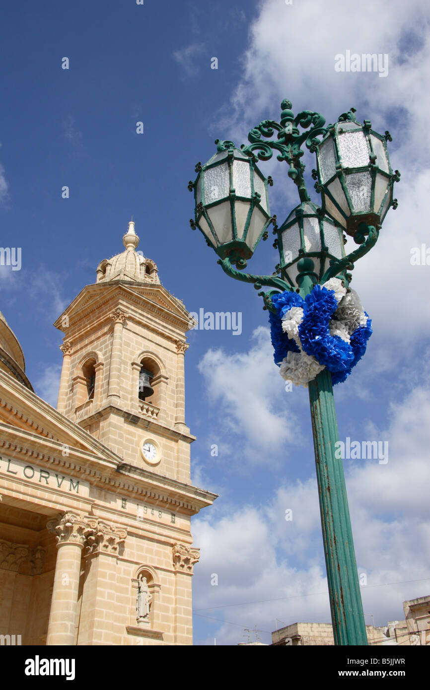 The "Church of Assumption" in Mgarr and one of it's ornate street lamps