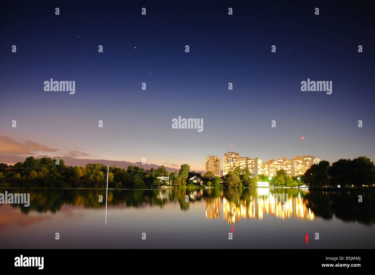 Brightly lit residential apartment buildings at Mooneys Bay waterfront
