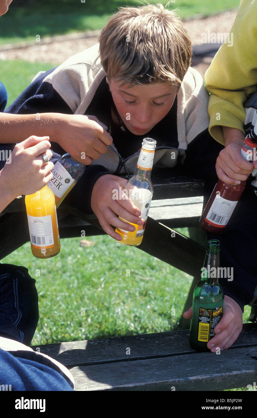 teenage boys drunk in park one about to vomit Stock Photo Alamy