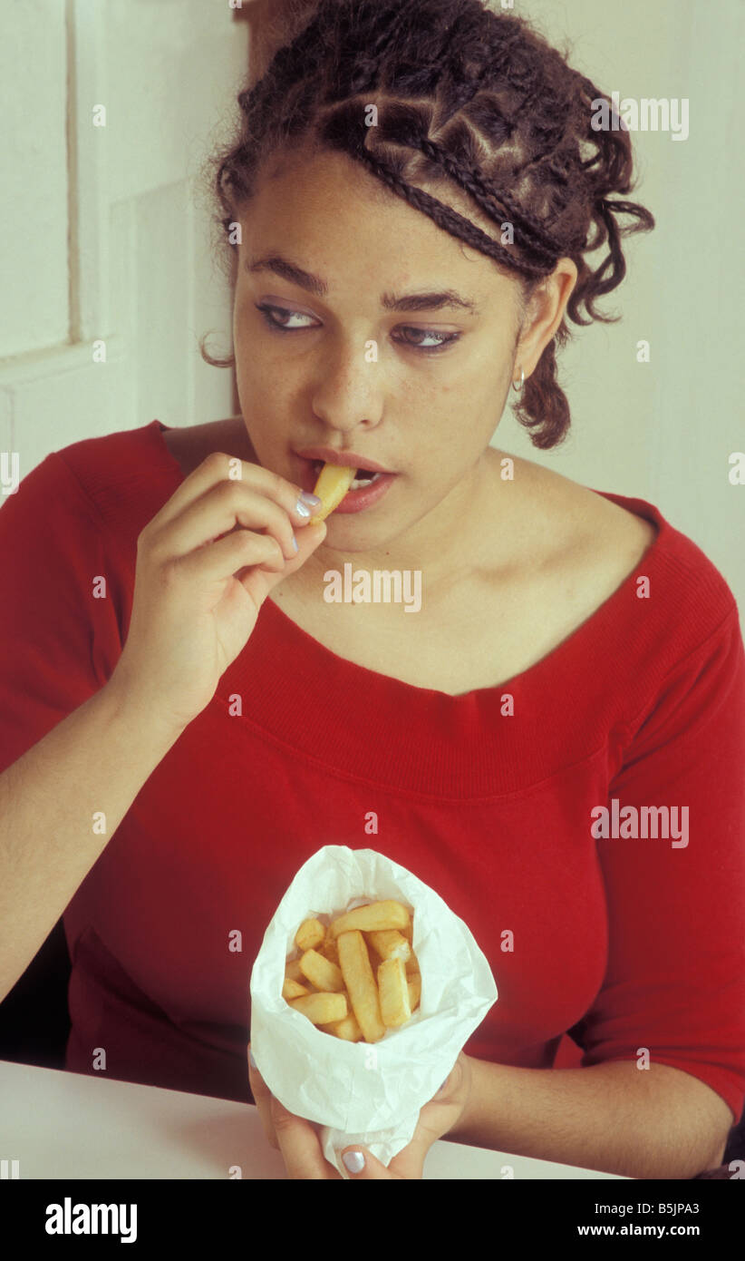 teenage girl eating bag of chips Stock Photo Alamy