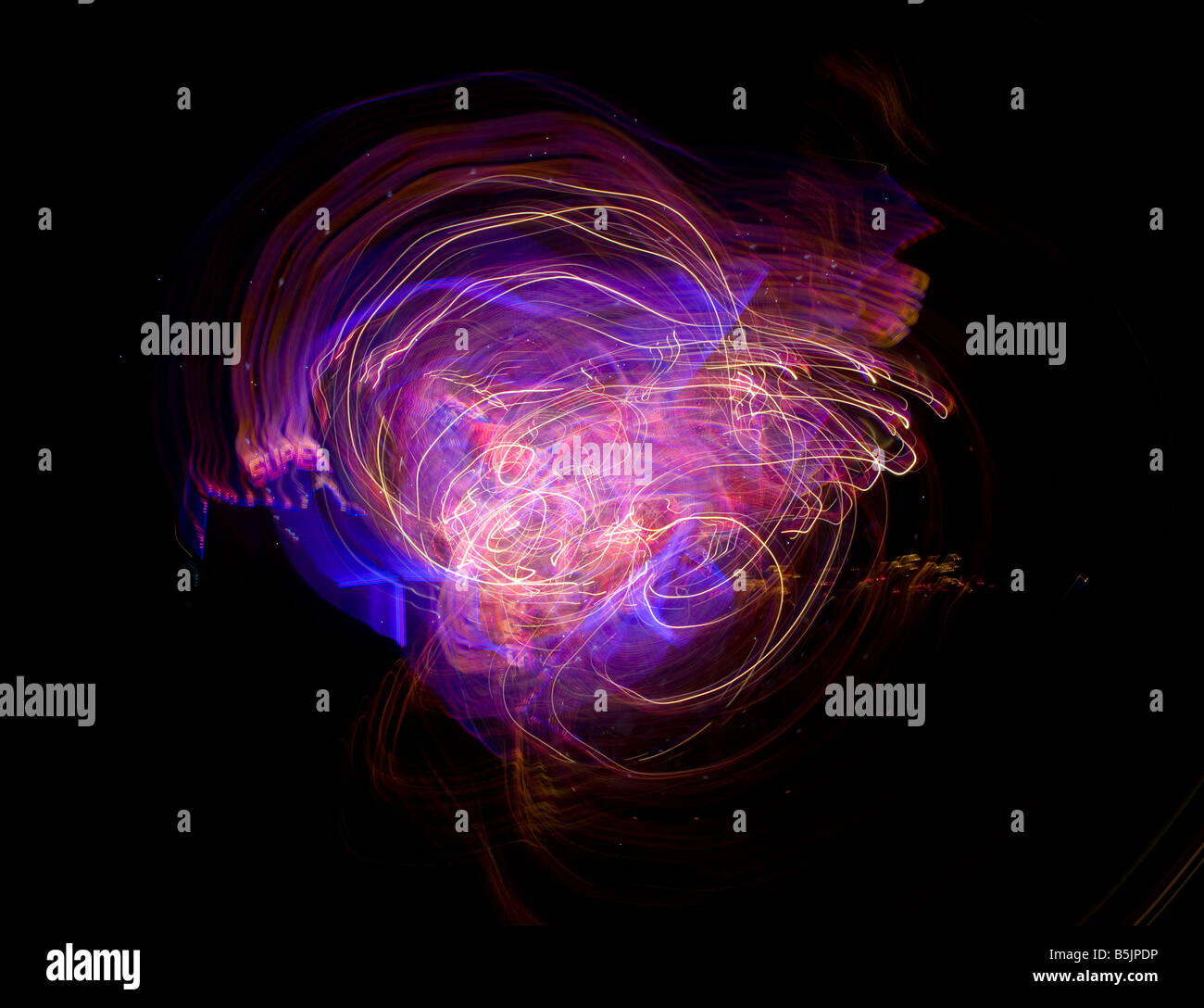 Colourful abstract light and lights fairground tails at night Stock
