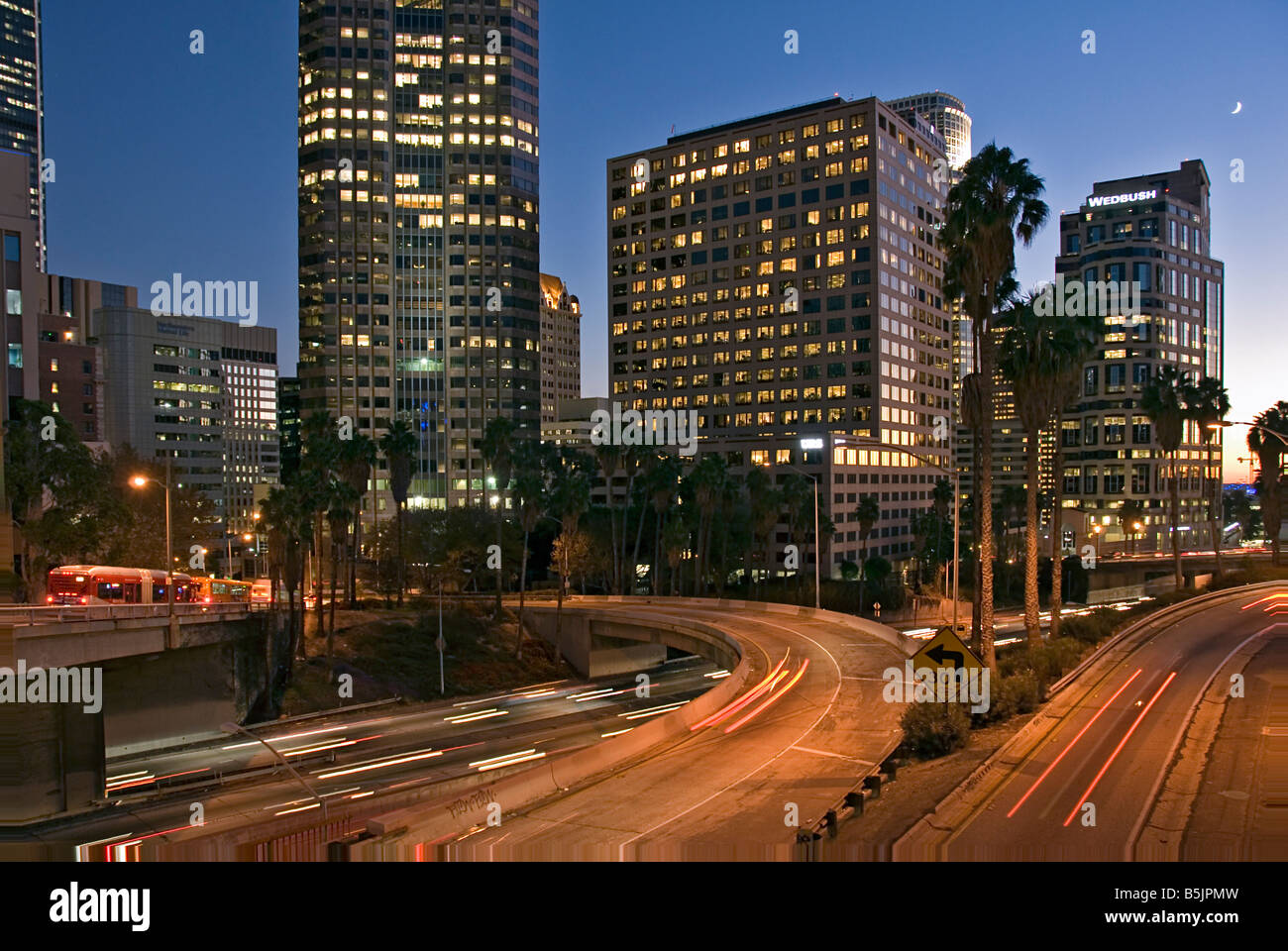 US 101, Harbor Freeway LA skyline, Dusk Los Angeles, California, USA Traffic moving CA LA city scape night Stock Photo