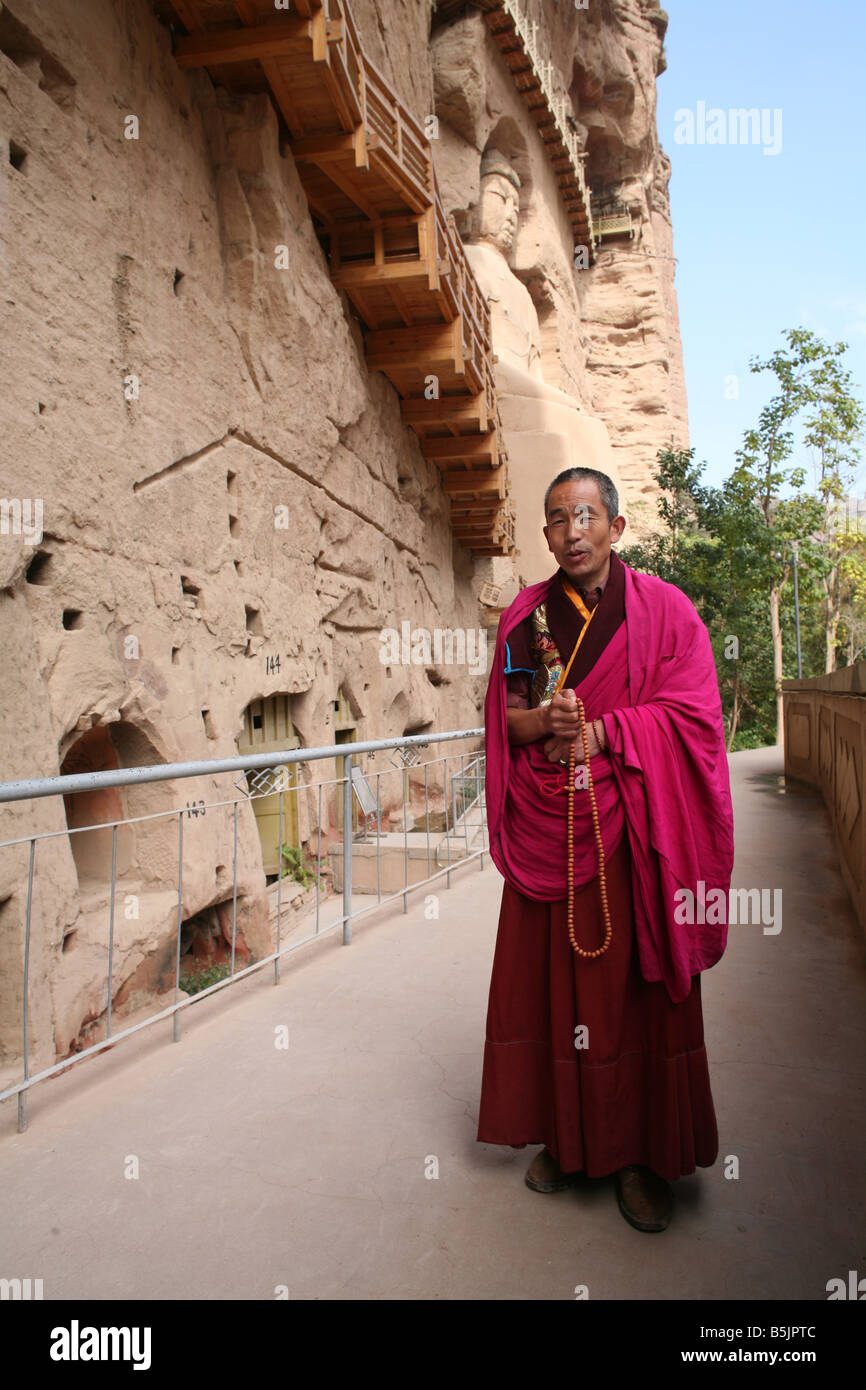 Tibetan monk and ancient caves Stock Photo