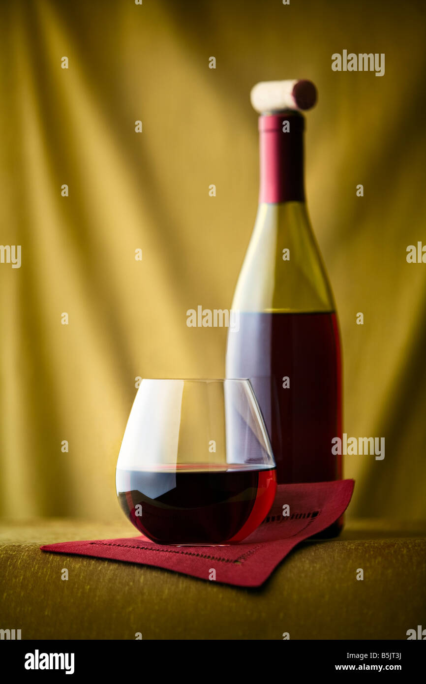 red wine in a short glass with bottle Stock Photo