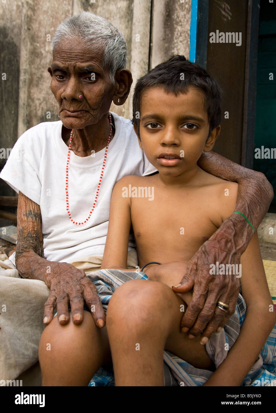 Mrs Mottaiamma 85 looks after her great grandson 11 who has MS multiple schlerosis Chennai Tamil Nadu India Stock Photo