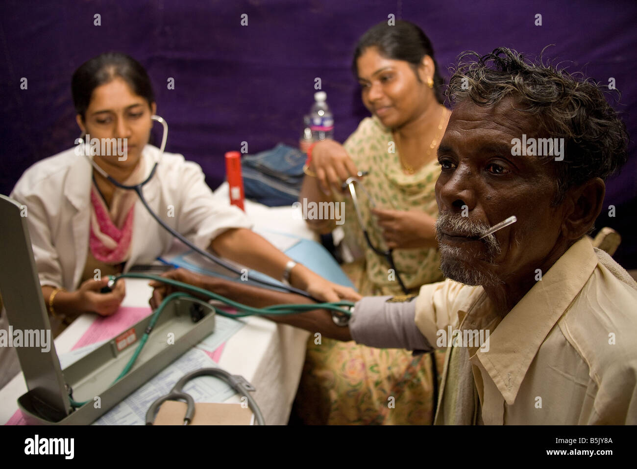 HelpAgeIndia sponsored cardiology health screening patient Mr Murugesan in makeshift lab in warehouse Cuddalore Stock Photo