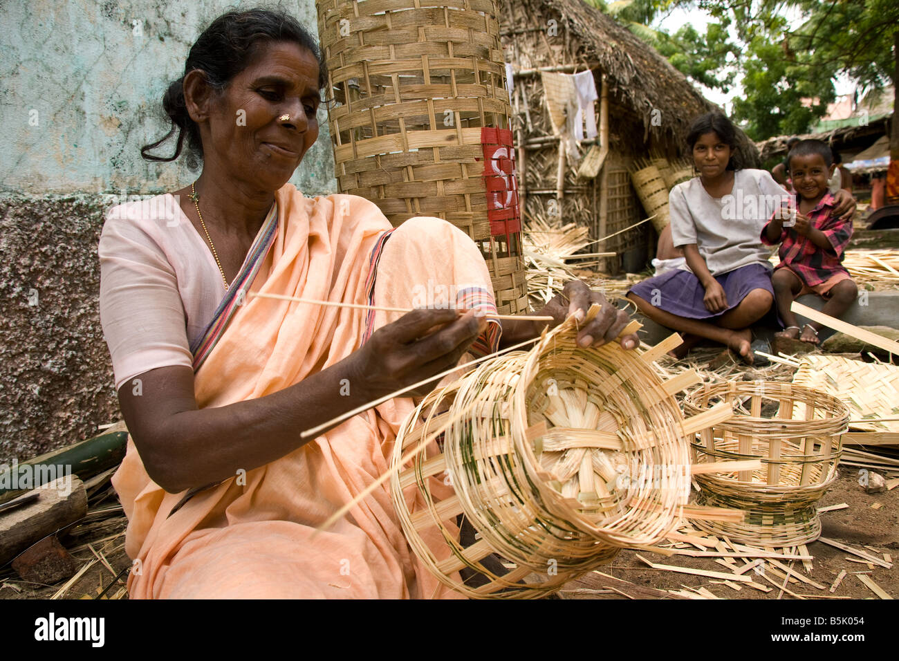 Tsunami displaced mother weaves a basket in self help group at Velipalayam Nagapattinam area Tamil Nadu Stock Photo