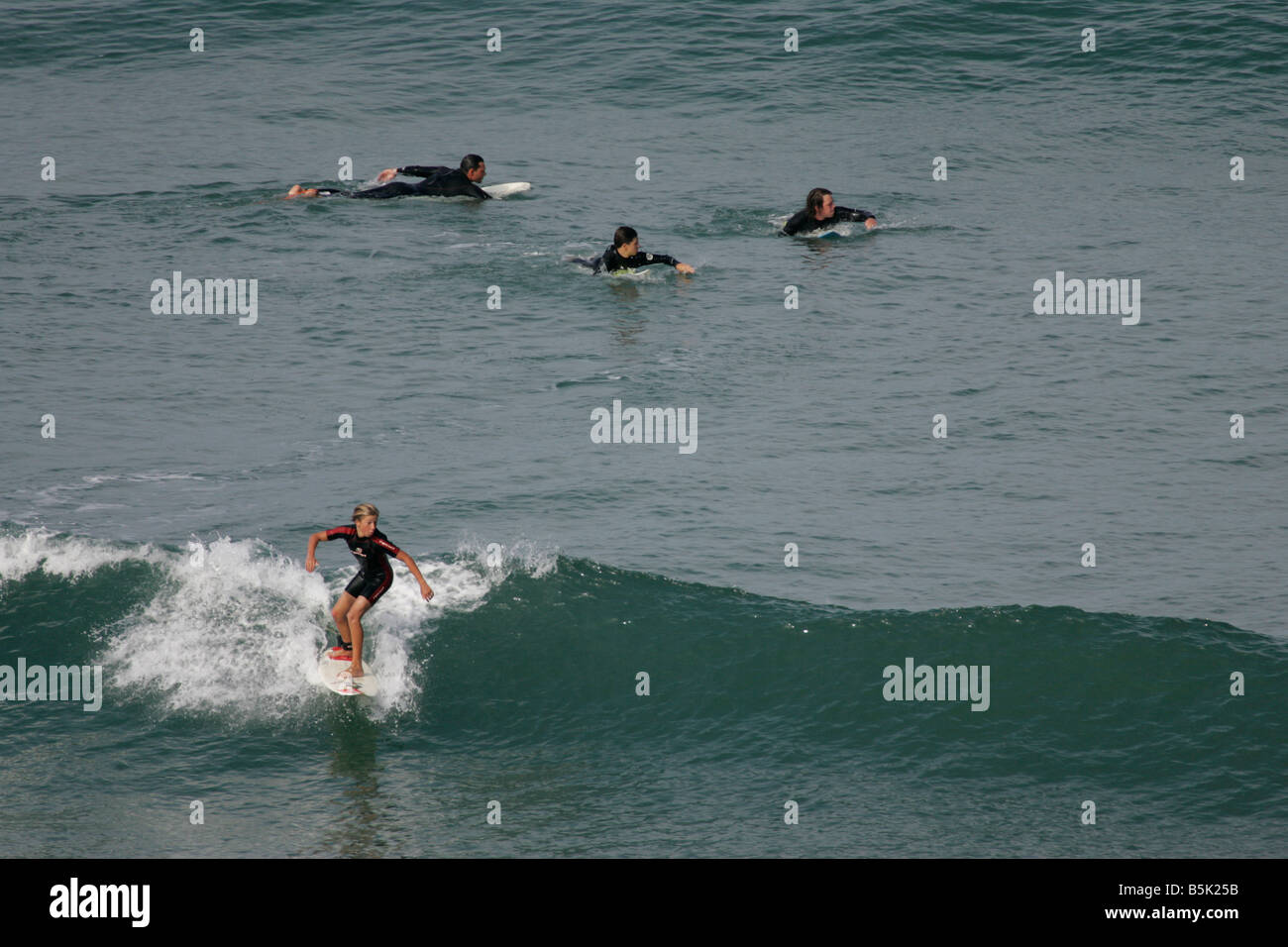 A Young Surfer riding a wave Stock Photo - Alamy