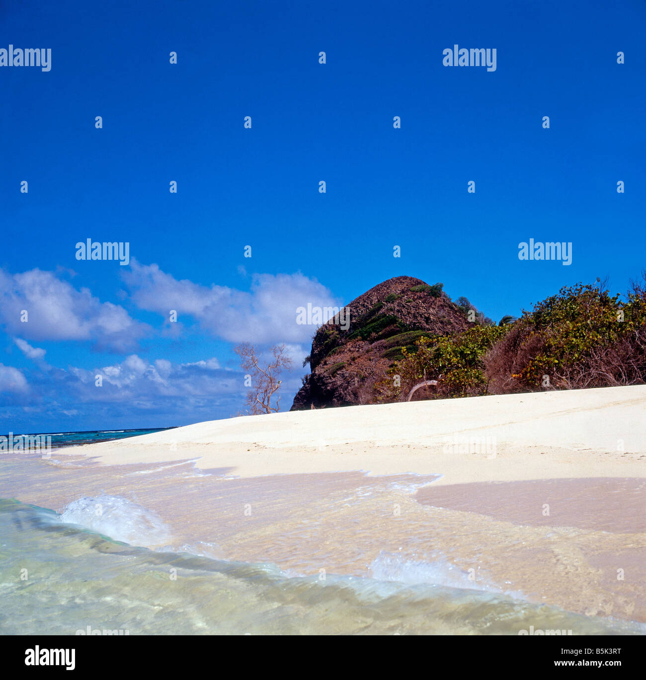 Sandy beach and blue sky, uninhabited island. Stock Photo