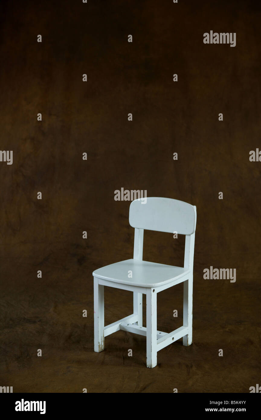 small white chair placed on brown studio background awaitng model  conceptual image of waiting and anticipation Stock Photo - Alamy