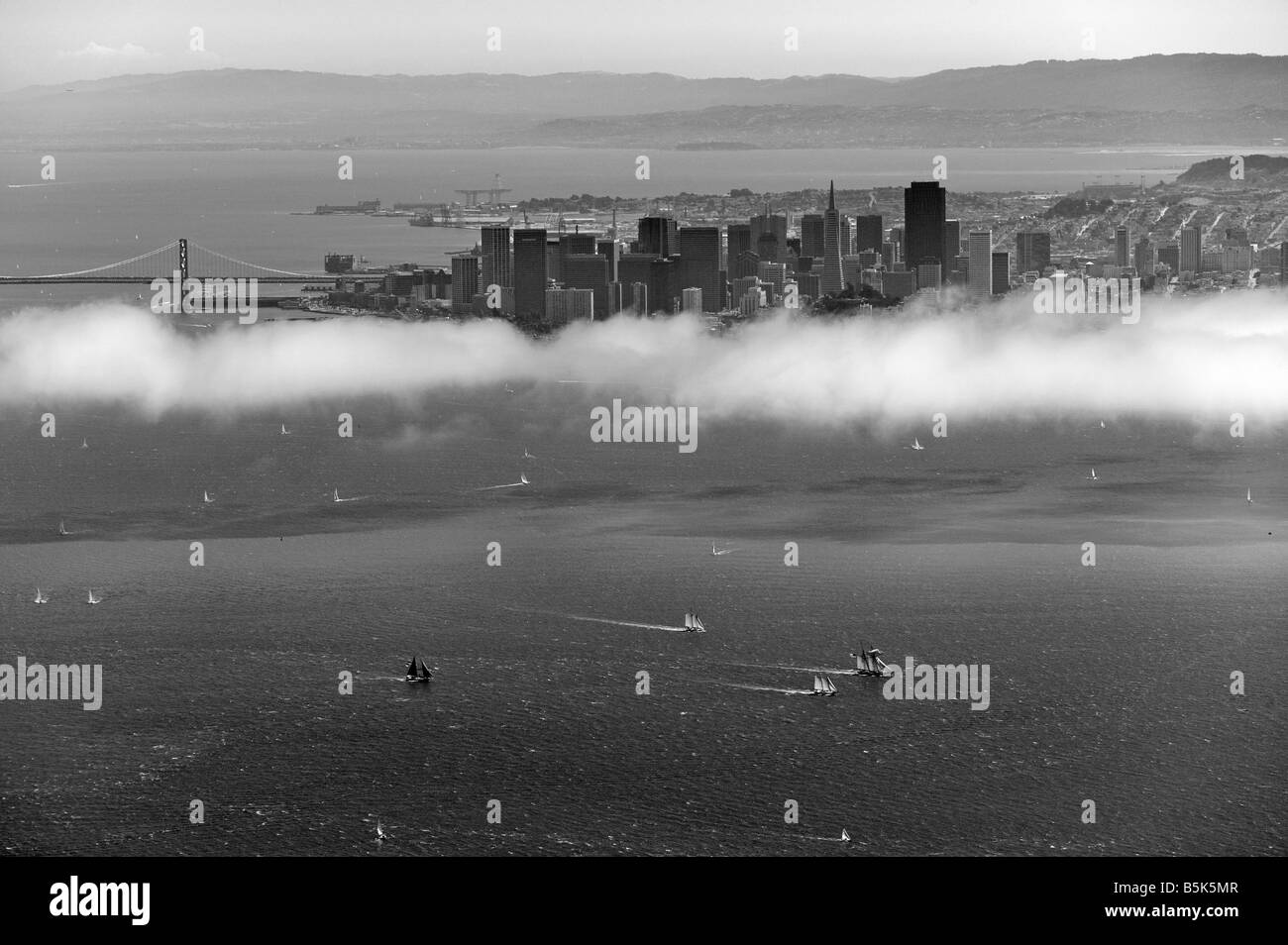 aerial view above sailboat racing San Francisco bay San Francisco skyline and bay bridge in background Stock Photo