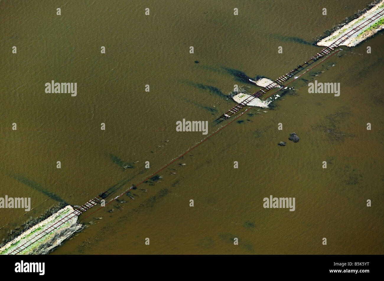 aerial view above flooding collapsed railroad track broken levee Sacramento San Joaquin river delta northern California Stock Photo