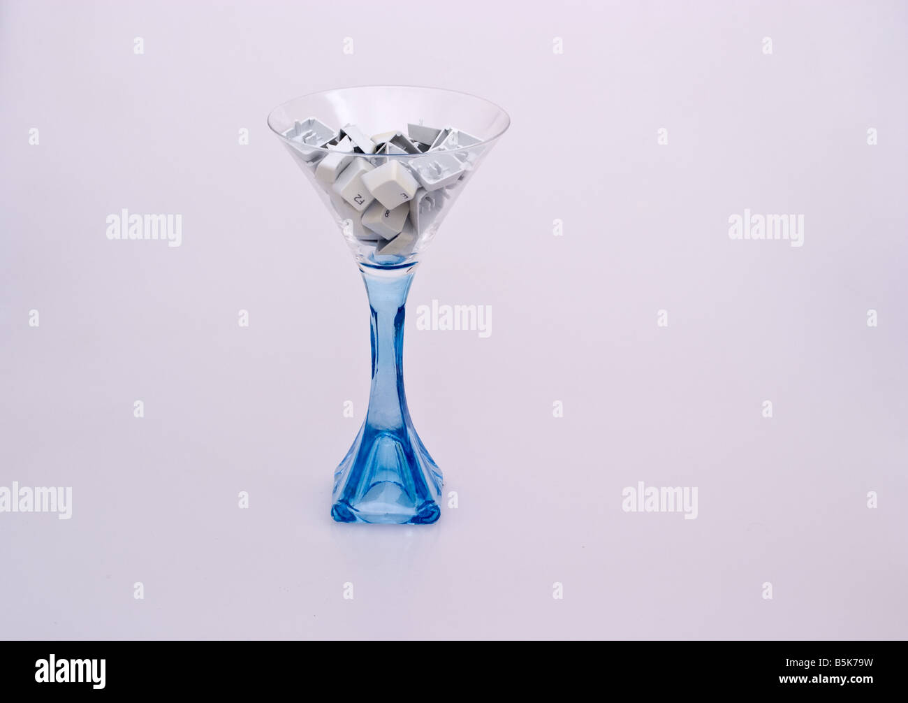 Light blue goblet filled with computer keys Stock Photo - Alamy