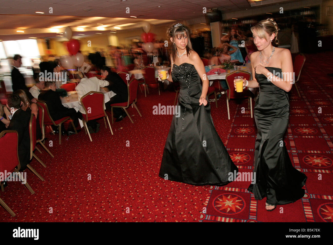 Teenage girls with soft drinks at their High School Prom at Southampton Football Club, England Stock Photo
