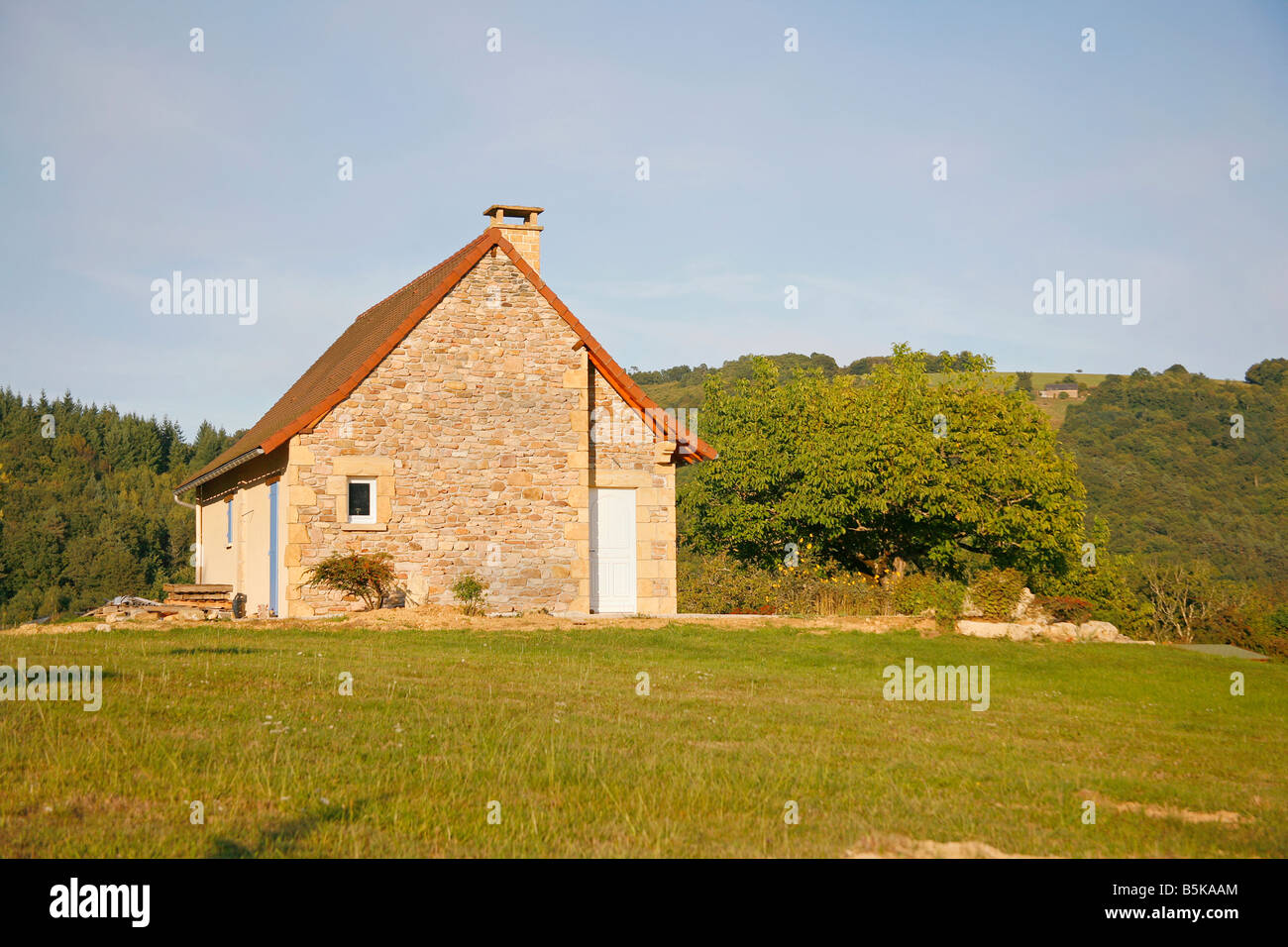 Stone house on hill in green garden Correze France Stock Photo