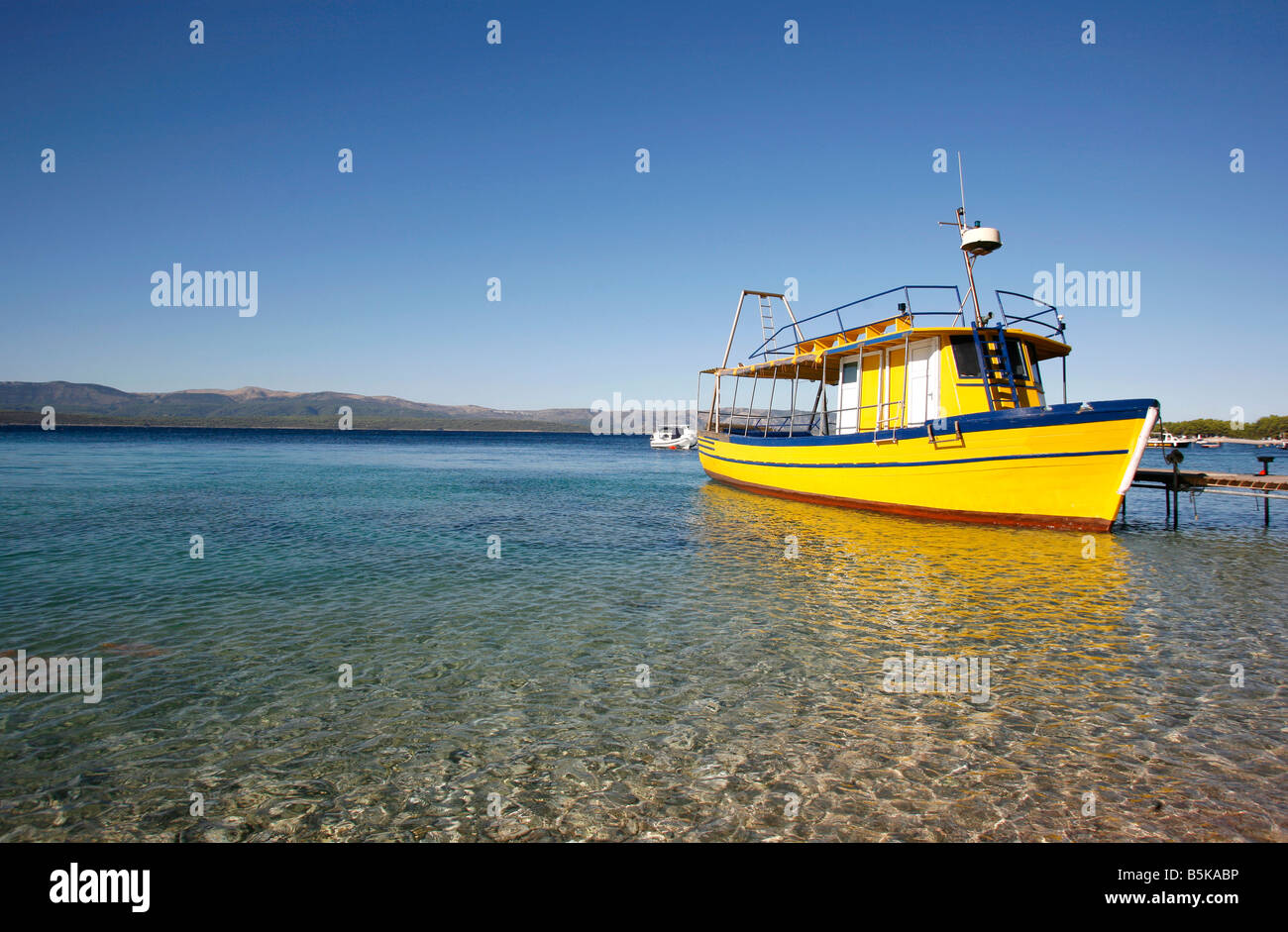 Yellow diving boat on Brac island Croatia Stock Photo