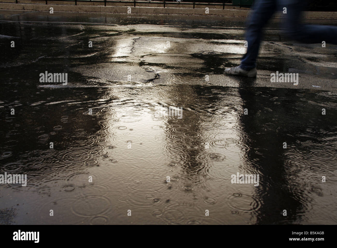 lots rain drops falling in water puddle in street Stock Photo Alamy