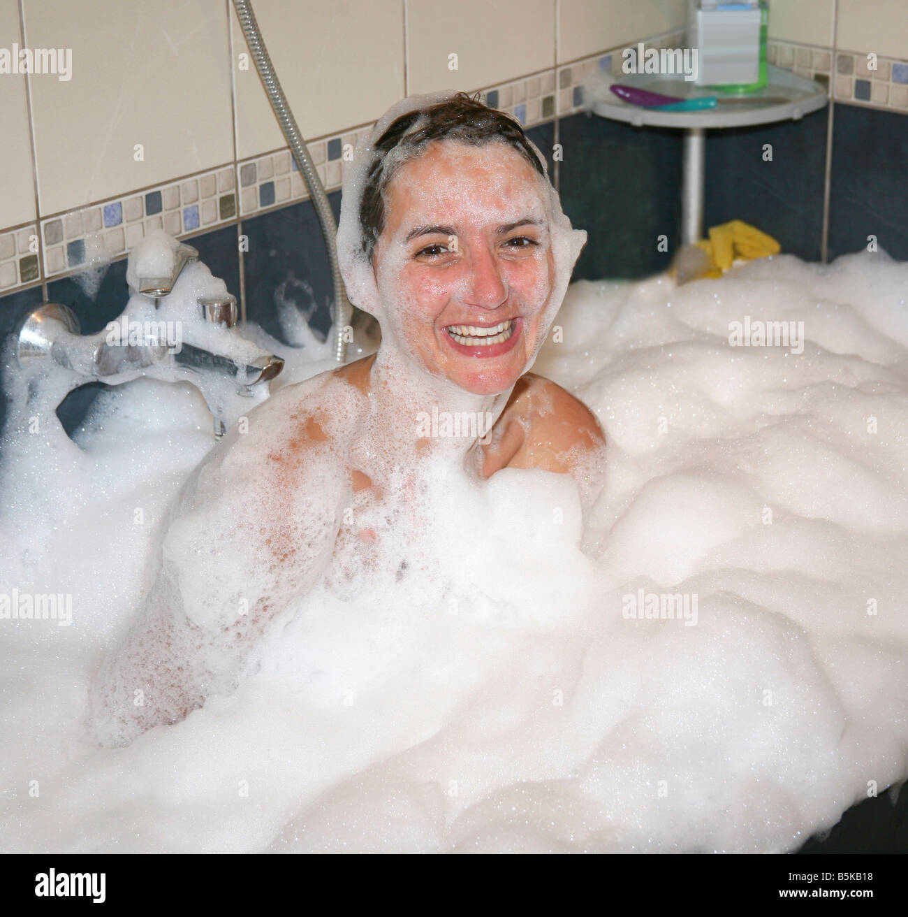 Woman having fun in foamy bath tub Stock Photo Alamy