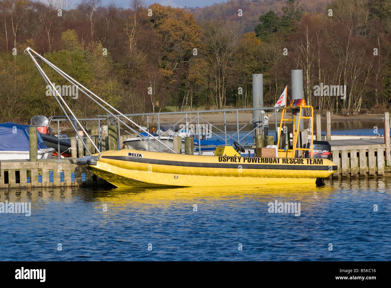 A Moored Yellow Rescue Rib with Crane Hoist at Coniston Water Powerboat Time Trials Lake District National Park England UK Stock Photo