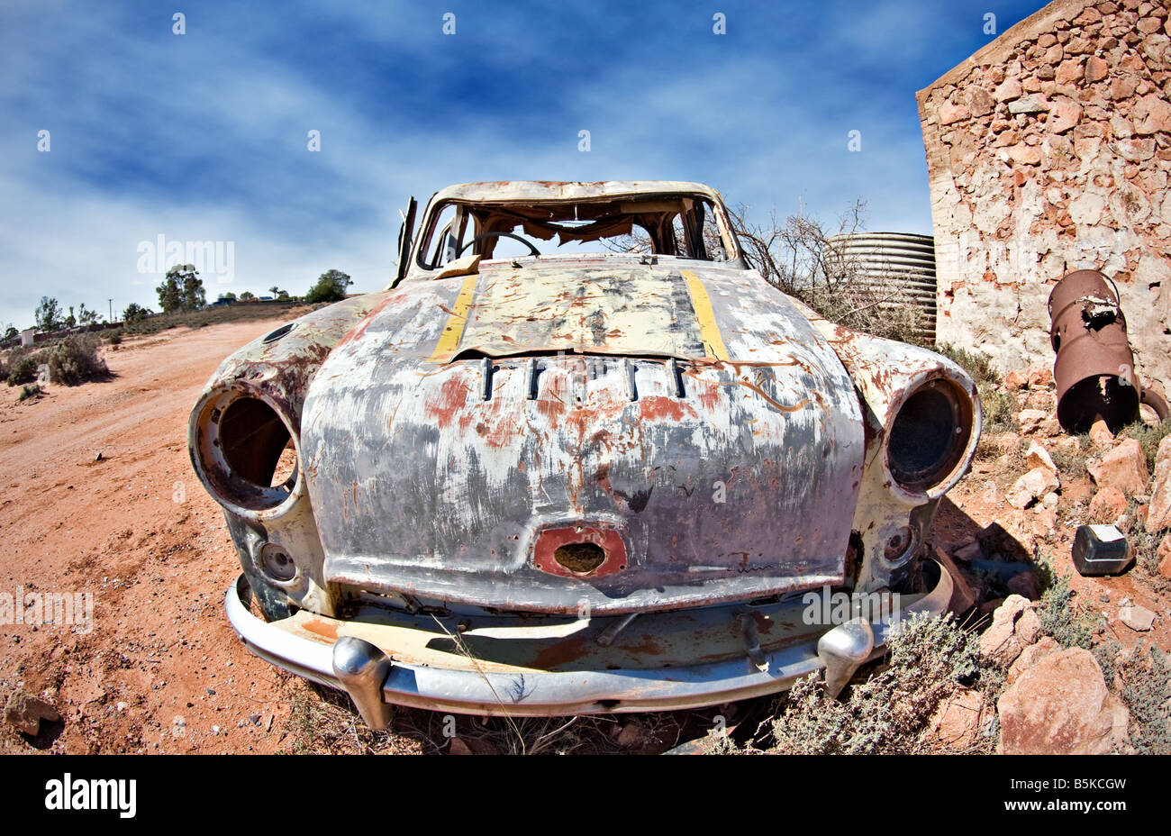 great image of an old car rusting away in the desert Stock Photo
