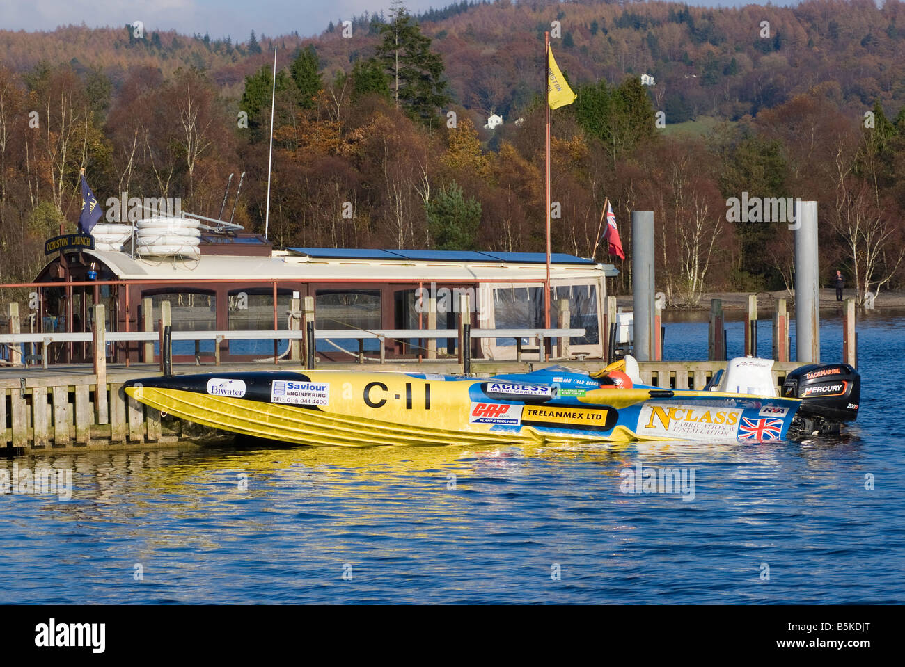 A Yellow Powerboat Moored to Pier at Coniston Water Speed Record Time