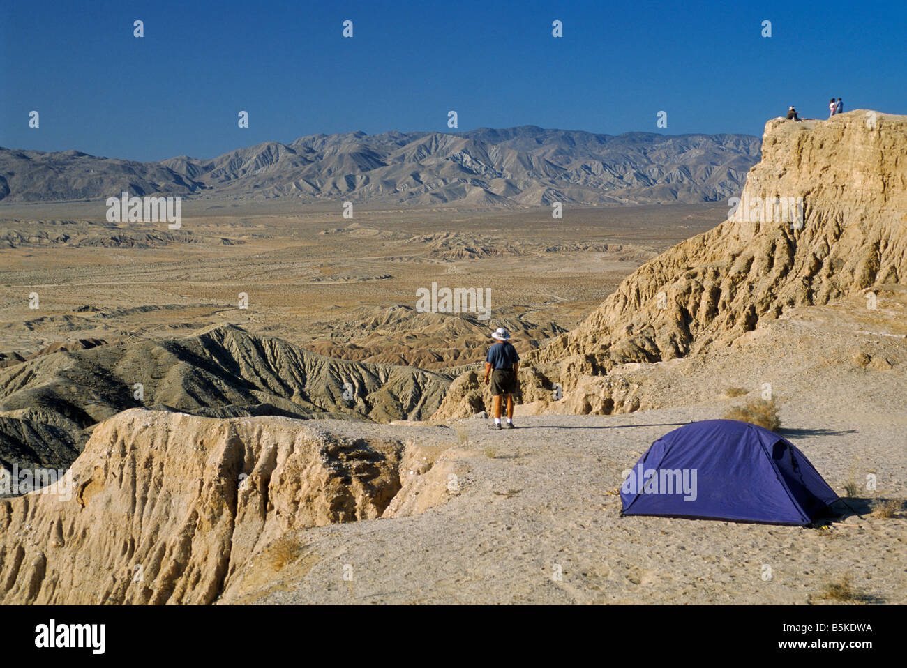 Camper at Fonts Point in Borrego Badlands with Vallecito Mountains in distance at Anza Borrego State Desert Park California USA Stock Photo