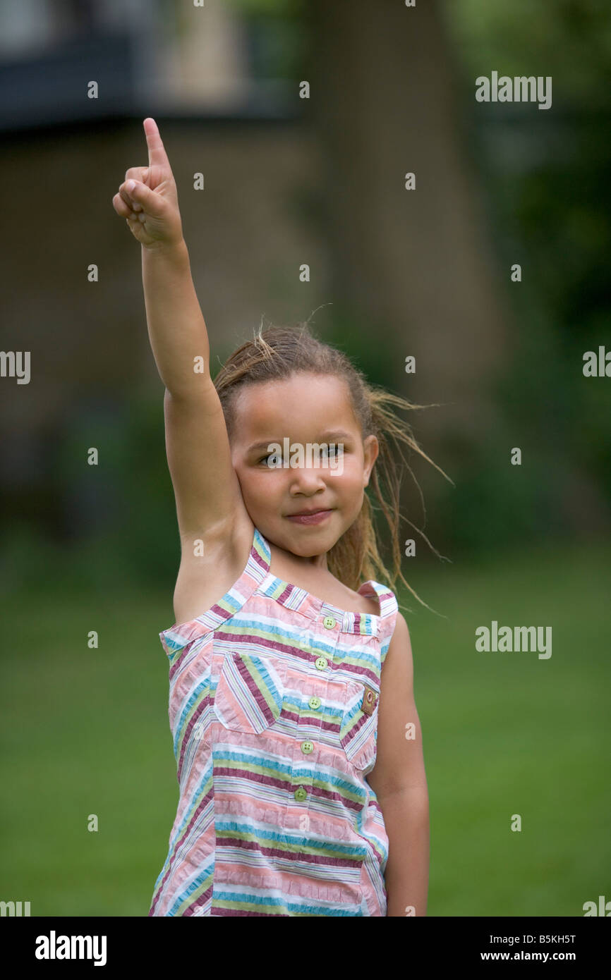 Girl raising her finger Stock Photo