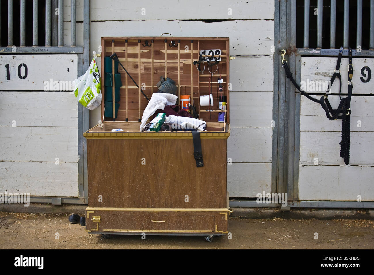 Tack box in front of horse stall used for storing equestrian equipment