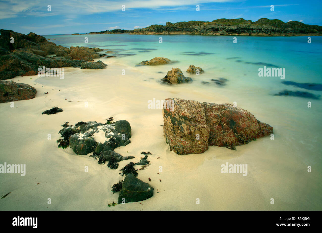 A view of a beutiful white sand beach and aquamarine sea on the west coast of the Isle of Iona in Scotland Stock Photo