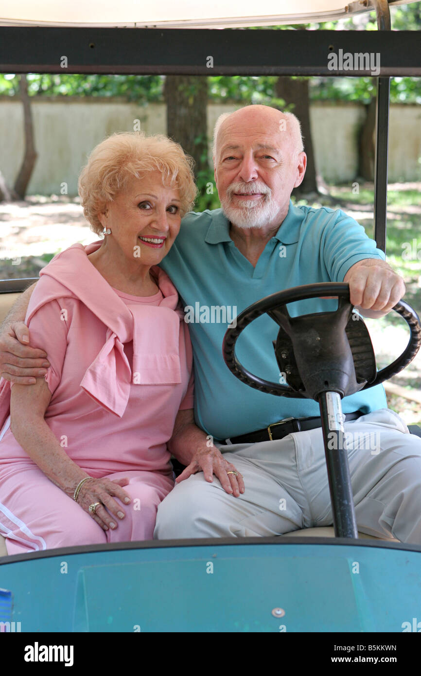A loving senior couple in a golf cart Stock Photo