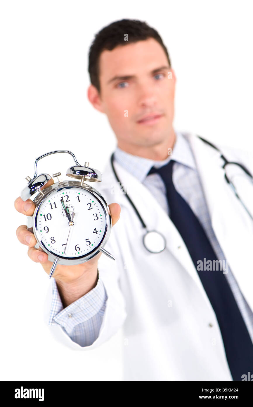 A male doctor holding out an alarm clock ticking ever closer to 12 o