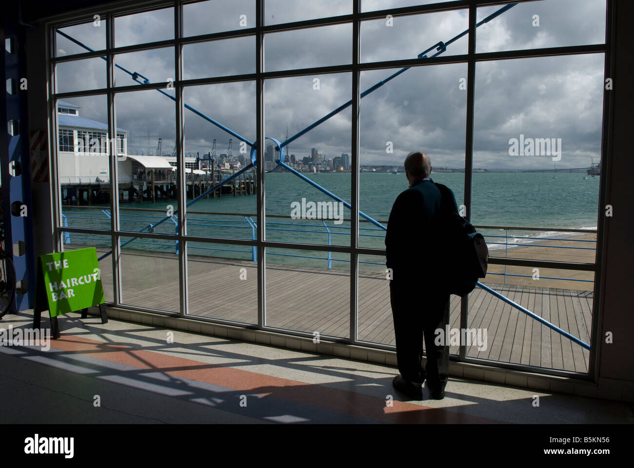 Man waiting for the Devonport ferry, Auckland, North island, New Zealand. Stock Photo