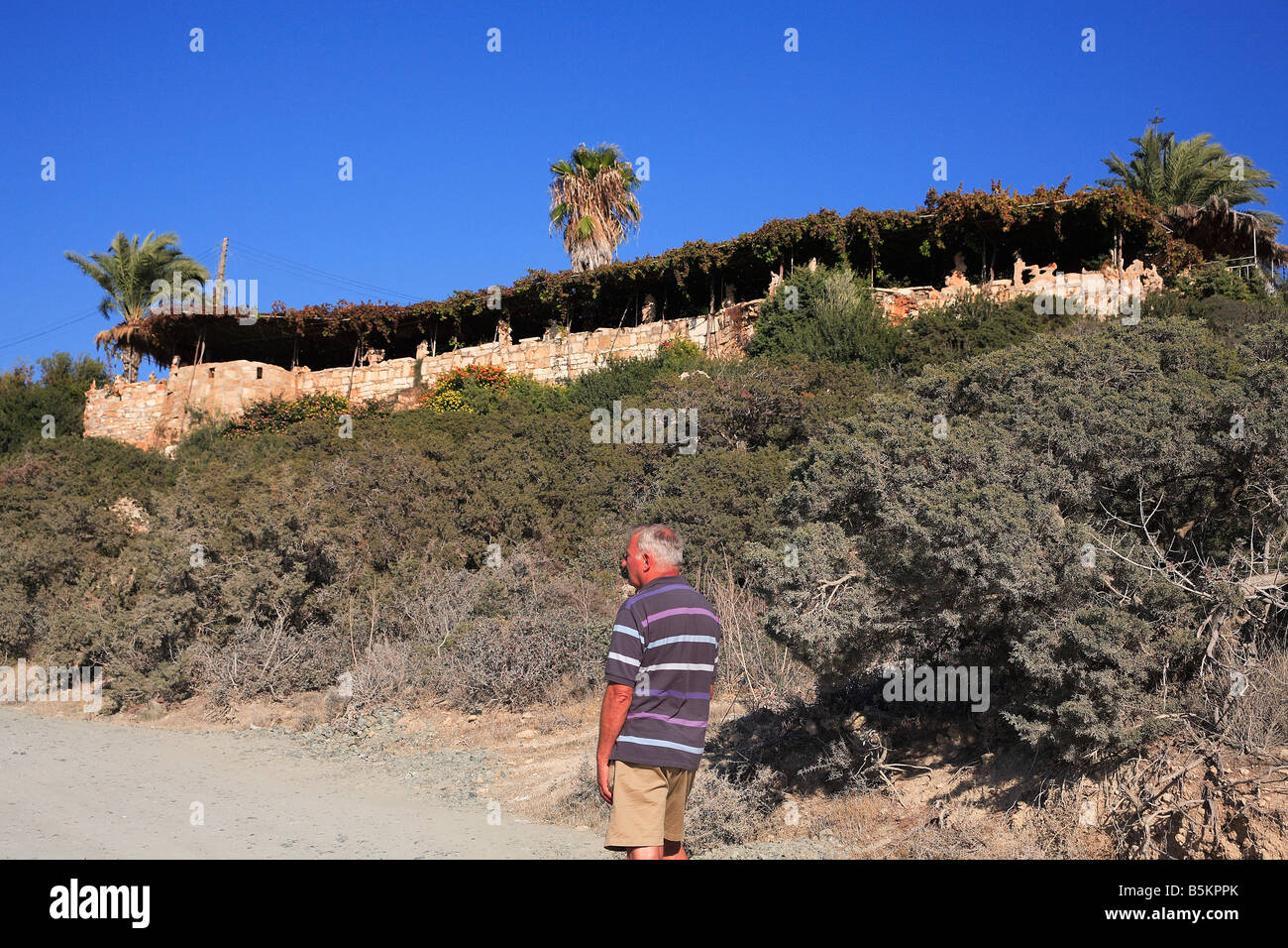 Older Man Looking At Viklari The Last Castle At Akamas Peninsula older-man-looking-at-viklari-the-last-castle-at-akamas-peninsula