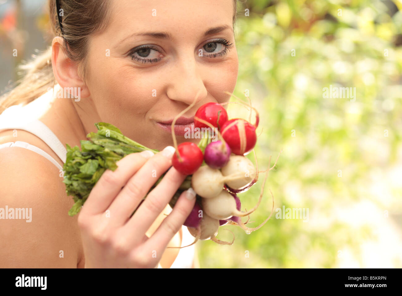 Young Woman Smelling Radishes Model Released Stock Photo Alamy