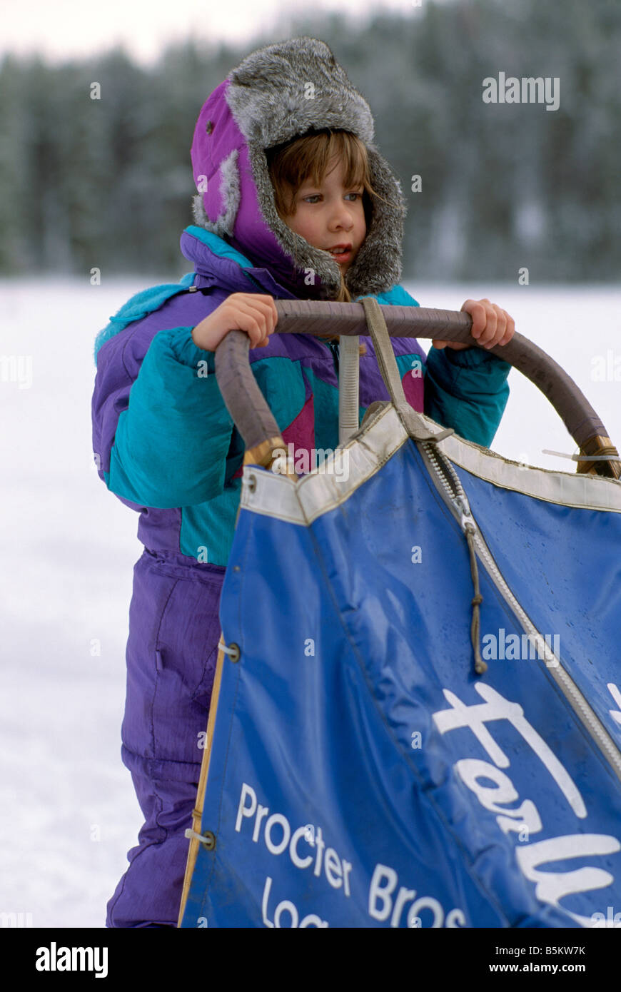 Young Child holding Sled at the International Sled Dog Race near Falkland in the Okanagan Region of British Columbia Canada Stock Photo