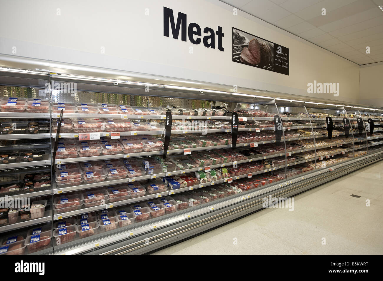 Meat stacked on supermarket shelves Supermarket interior Stock Photo
