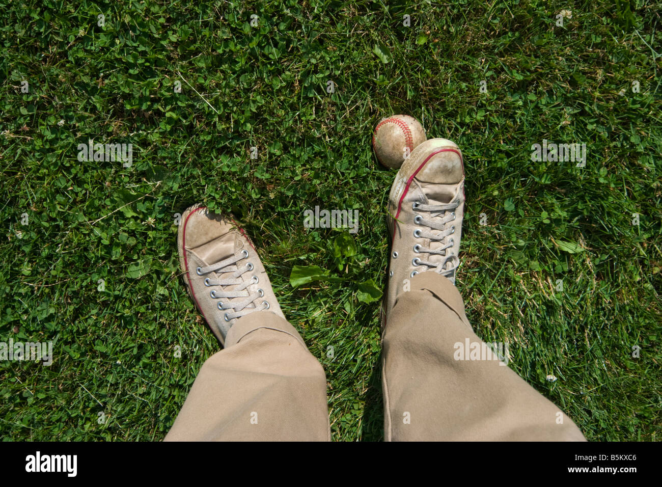 Close up of a man s feet with one foot standing on a baseball MODEL RELEASED Stock Photo