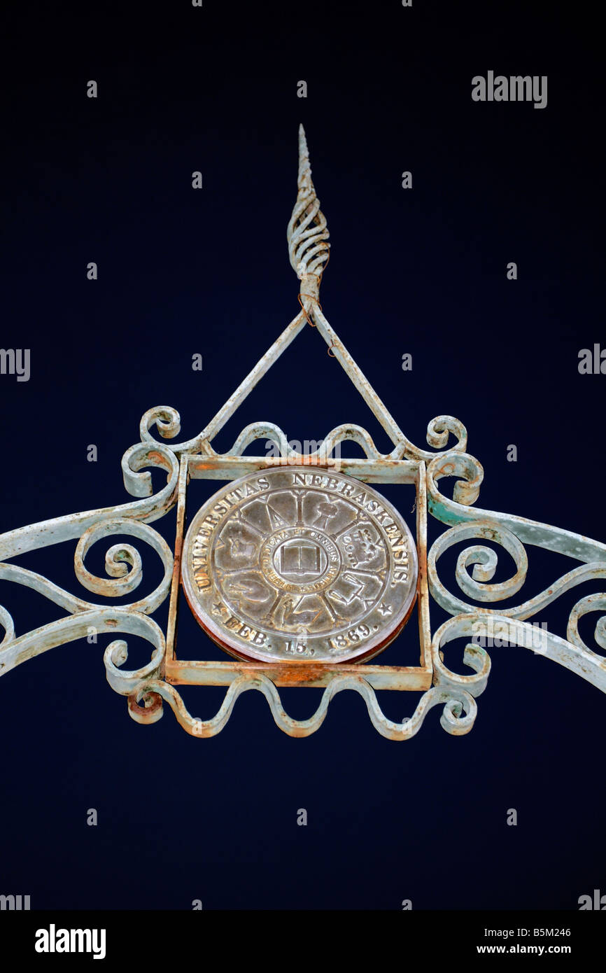 Bronzed weathered iron arch with centered round bronze medallion: Universitas Nebraskensis. Stock Photo